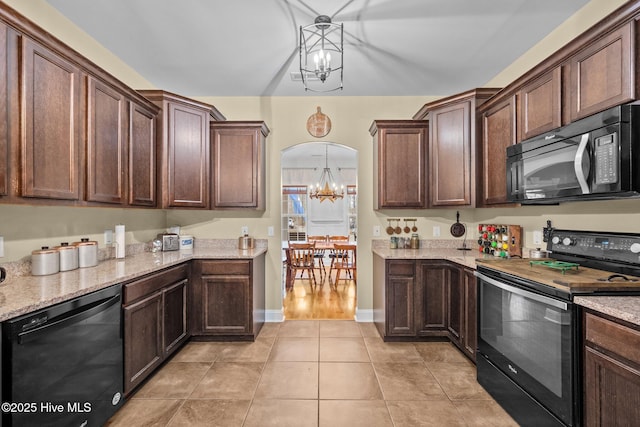 kitchen with pendant lighting, a notable chandelier, dark brown cabinets, and black appliances