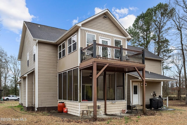 rear view of property with a sunroom