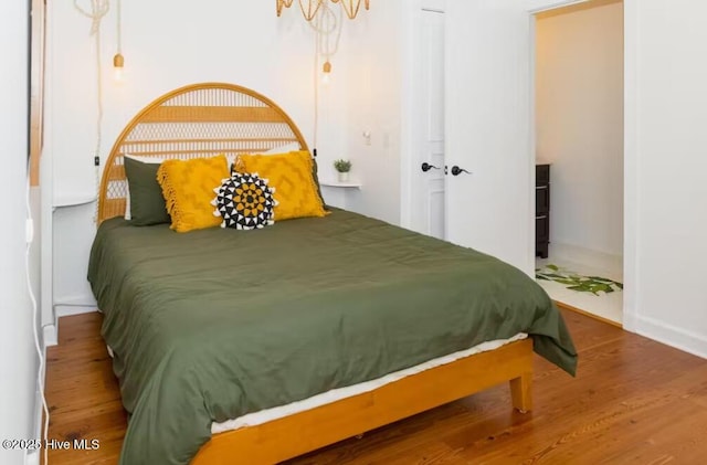 bedroom with hardwood / wood-style floors