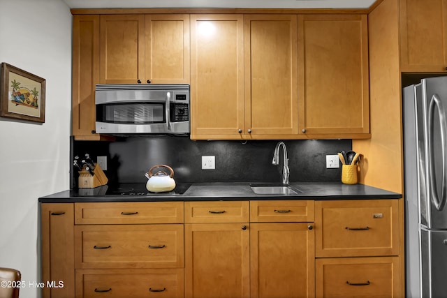 kitchen featuring stainless steel appliances, sink, and backsplash