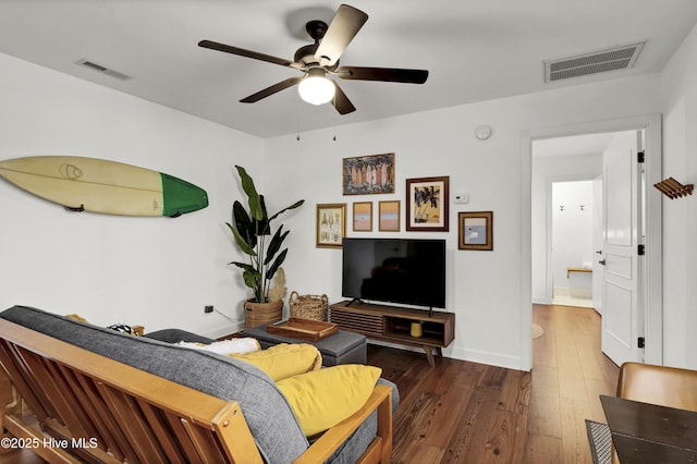 living room featuring ceiling fan and dark hardwood / wood-style flooring