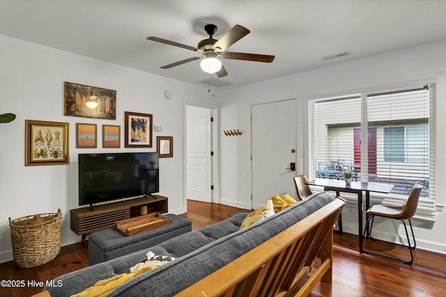 living room with ceiling fan and dark hardwood / wood-style floors