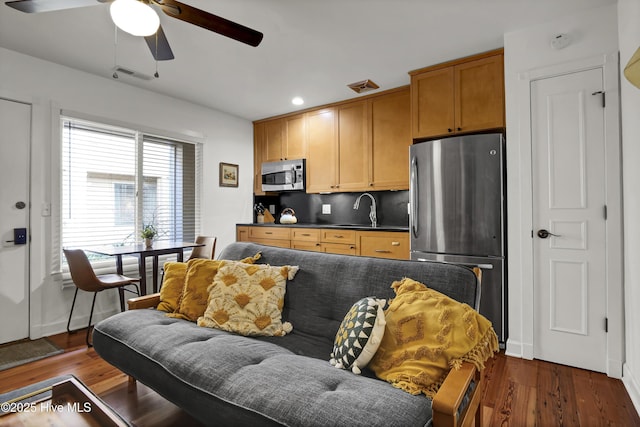 interior space featuring dark hardwood / wood-style flooring, sink, and ceiling fan