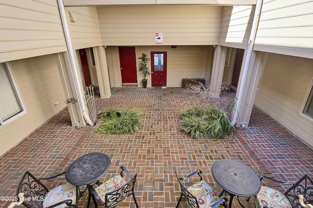 property entrance featuring a patio