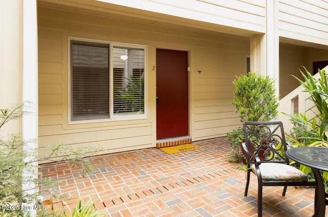 doorway to property with a patio area