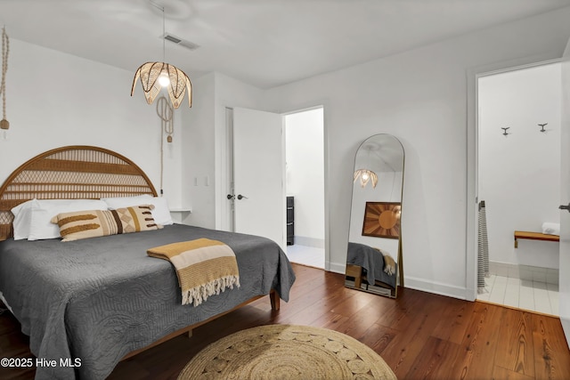 bedroom with dark wood-type flooring