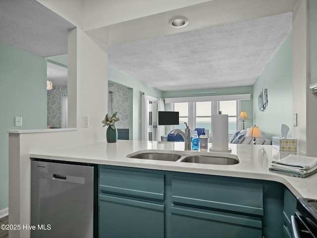 kitchen with dishwasher, sink, stove, kitchen peninsula, and a textured ceiling