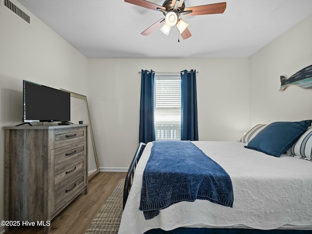 bedroom featuring dark hardwood / wood-style floors and ceiling fan