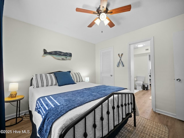 bedroom with ensuite bath, wood-type flooring, and ceiling fan