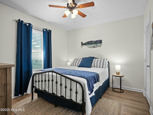 bedroom featuring hardwood / wood-style floors and ceiling fan