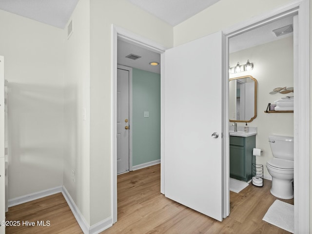 bathroom featuring hardwood / wood-style flooring, vanity, and toilet