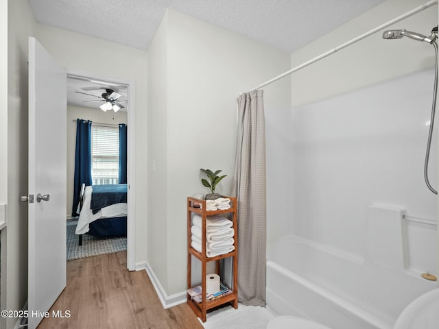 bathroom featuring shower / tub combo with curtain, hardwood / wood-style floors, a textured ceiling, and ceiling fan