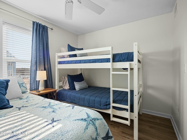 bedroom with dark wood-type flooring and ceiling fan