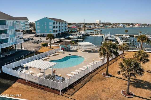 view of swimming pool featuring a water view and a patio area