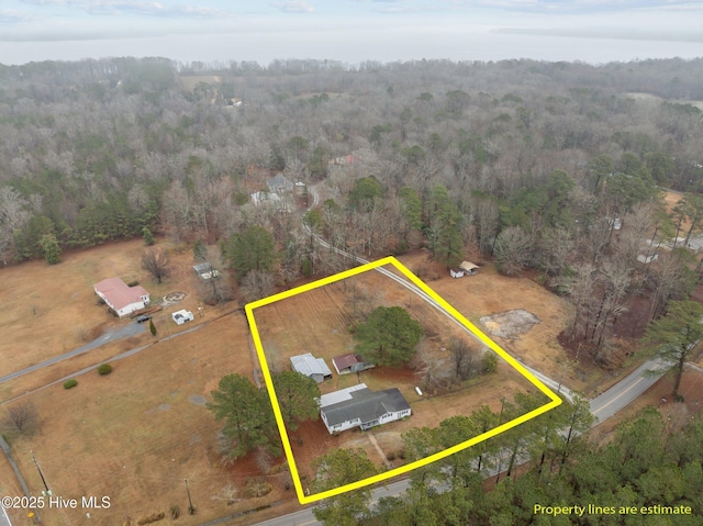 birds eye view of property featuring a wooded view