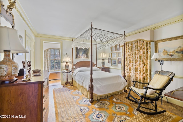 bedroom with parquet floors and crown molding