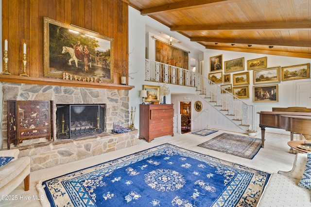 living room featuring lofted ceiling with beams, a fireplace, and wood ceiling