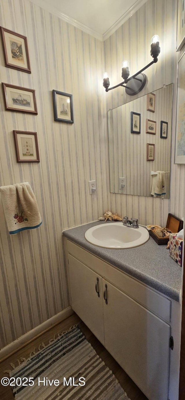 bathroom with vanity and ornamental molding