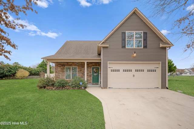 view of front property with a garage, a front yard, and covered porch