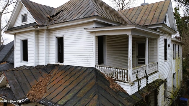 view of property exterior with covered porch