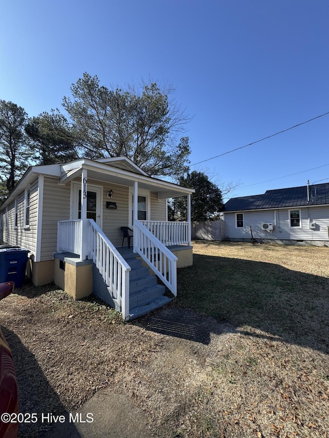 view of front of home featuring a front yard and covered porch