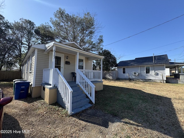 bungalow with a porch and a front yard