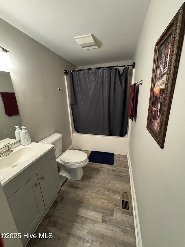 full bathroom with toilet, vanity, shower / bathtub combination with curtain, and hardwood / wood-style flooring