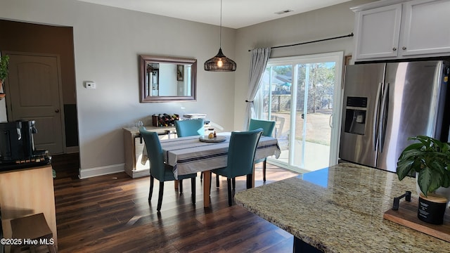 dining area featuring dark wood-type flooring