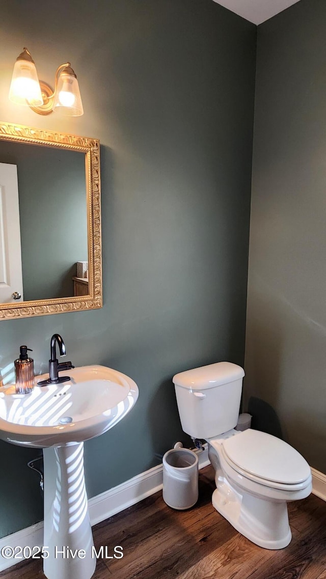 bathroom featuring hardwood / wood-style floors and toilet