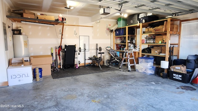 garage with a garage door opener and electric water heater