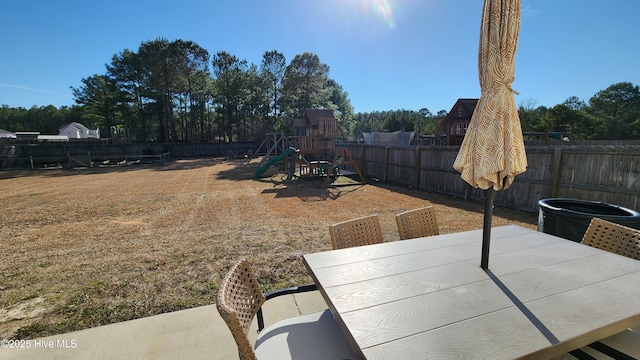 view of yard with a playground and a patio