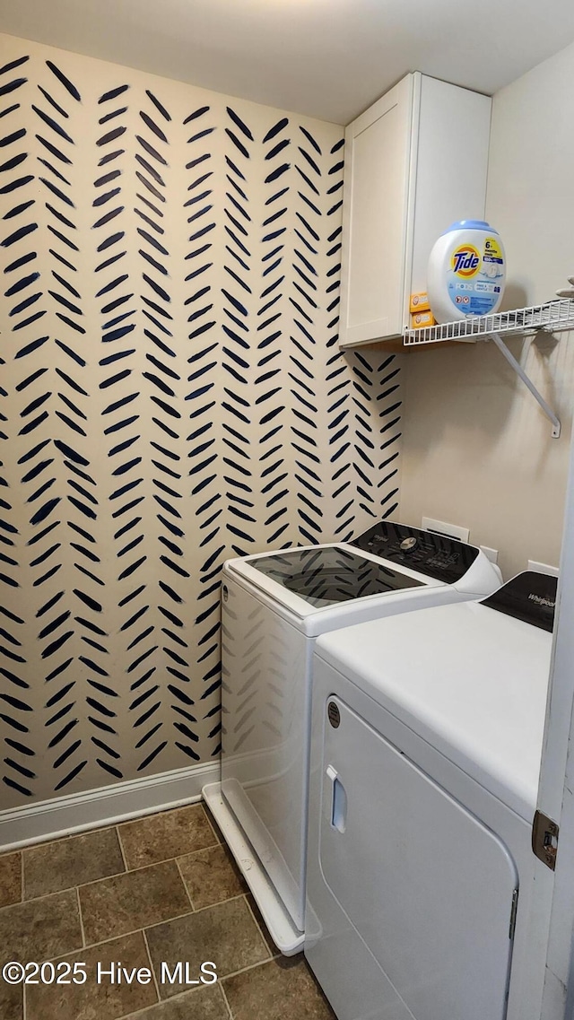 laundry room featuring cabinets and washing machine and dryer