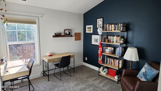 carpeted office space with vaulted ceiling