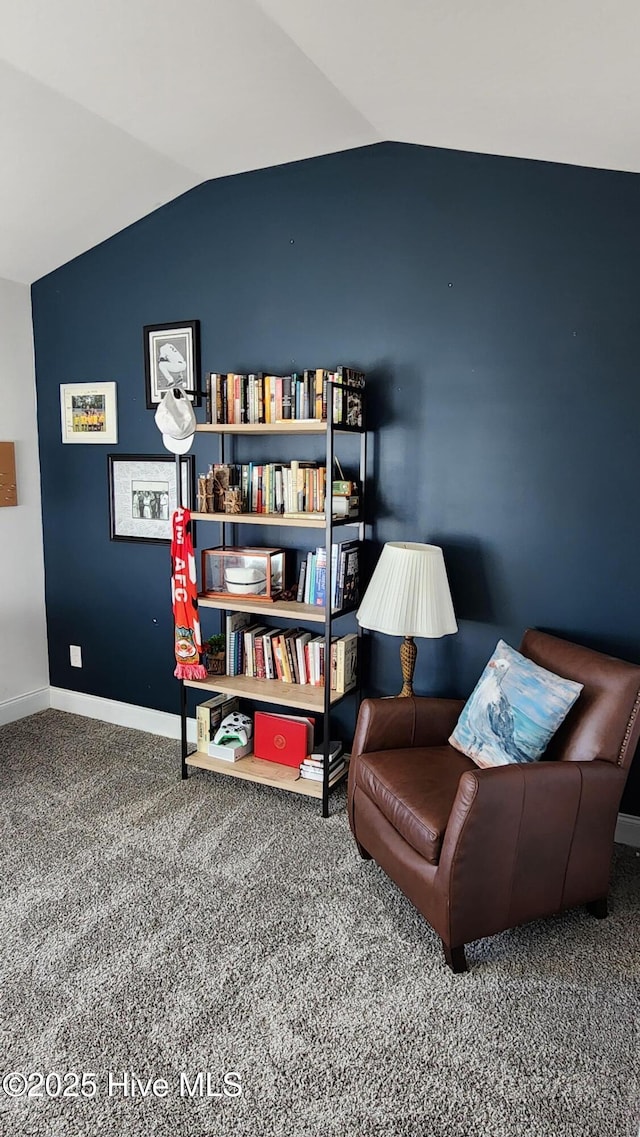 sitting room with lofted ceiling and carpet