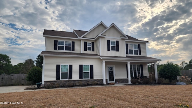 craftsman inspired home featuring a front yard and a porch