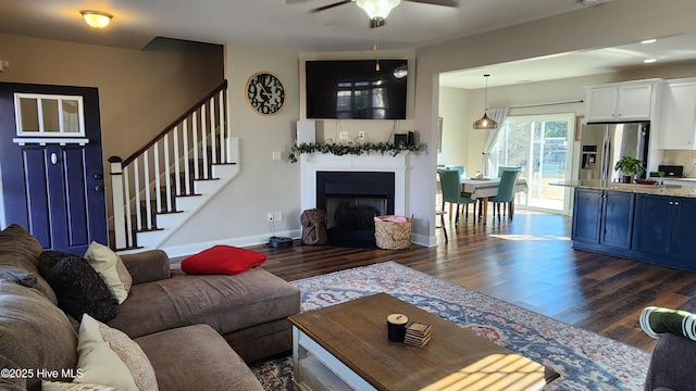 living room featuring ceiling fan and dark hardwood / wood-style flooring