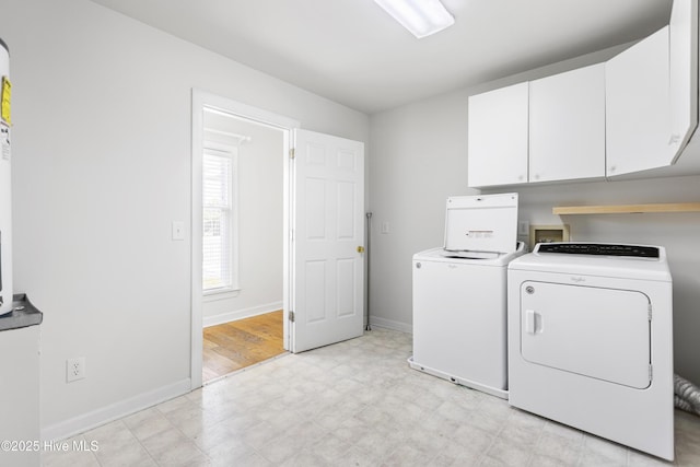 washroom with cabinets and washer and dryer