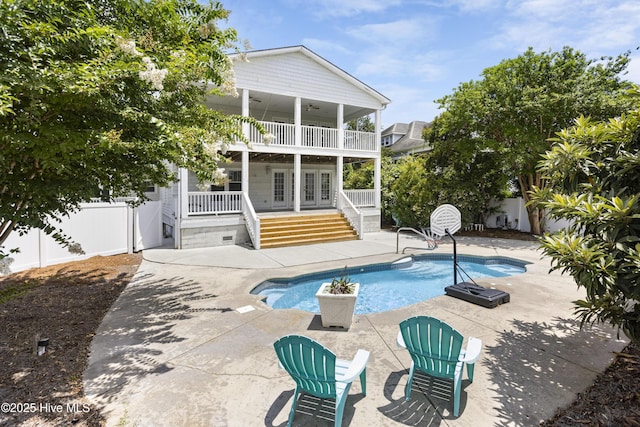 view of swimming pool with a patio and french doors