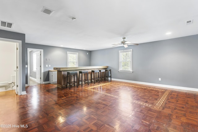 empty room featuring dark parquet flooring and ceiling fan