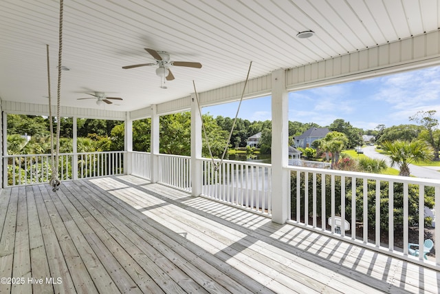 wooden deck featuring ceiling fan