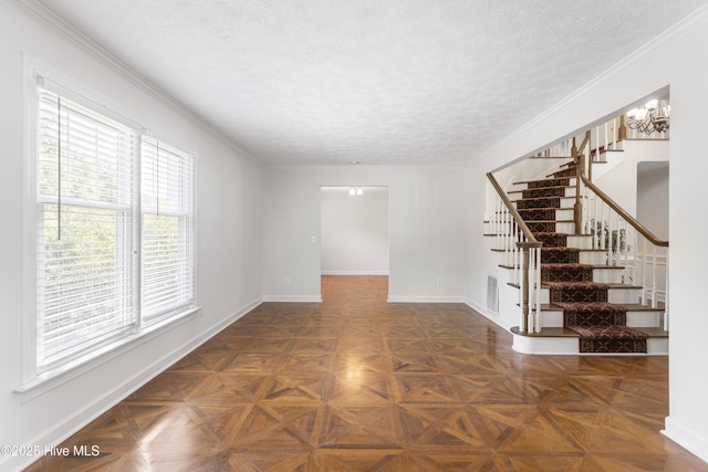 empty room with dark parquet flooring, ornamental molding, and a textured ceiling