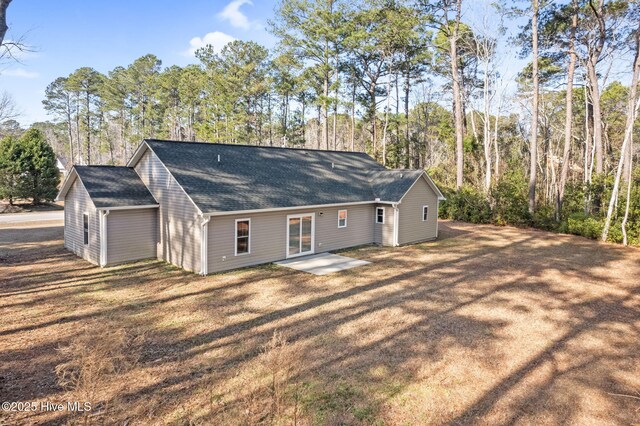 back of property with a patio and a lawn