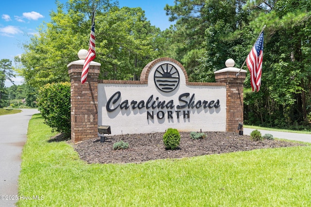 community / neighborhood sign with a lawn