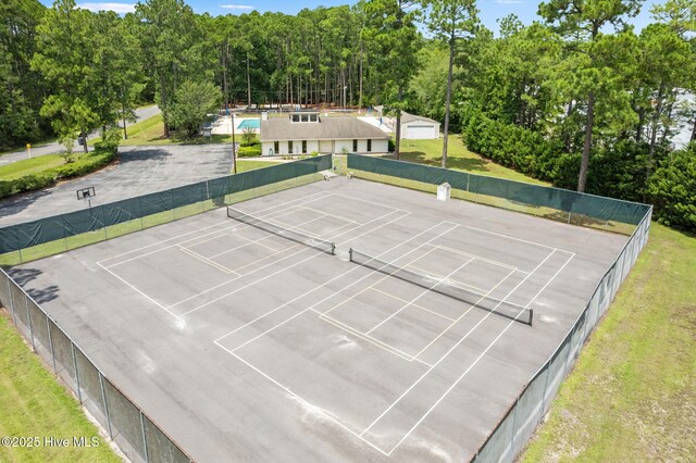 community pool with fence, a patio area, and a lawn