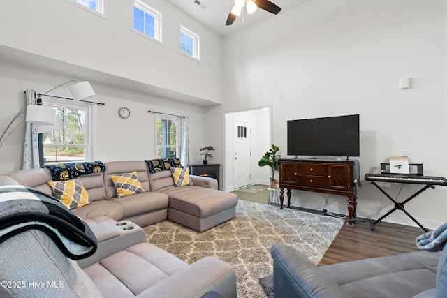 kitchen featuring stainless steel dishwasher, gray cabinetry, a wealth of natural light, and wood finished floors