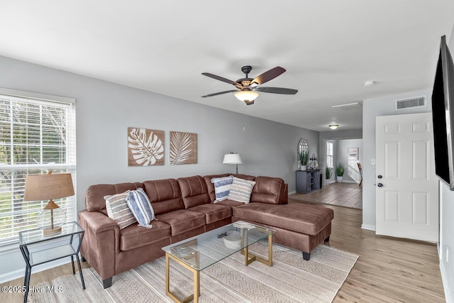 living room with ceiling fan and light hardwood / wood-style flooring