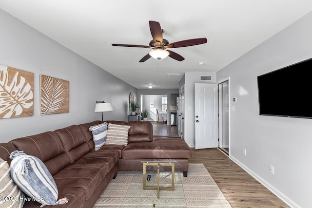 living room featuring ceiling fan and wood-type flooring