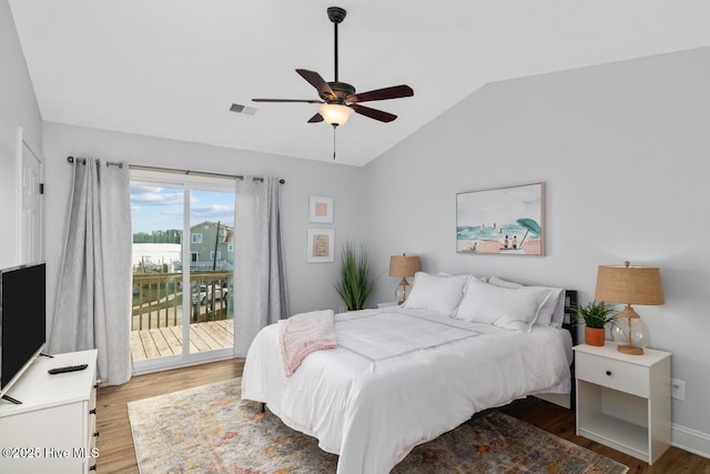 bedroom with lofted ceiling, hardwood / wood-style floors, access to outside, and ceiling fan