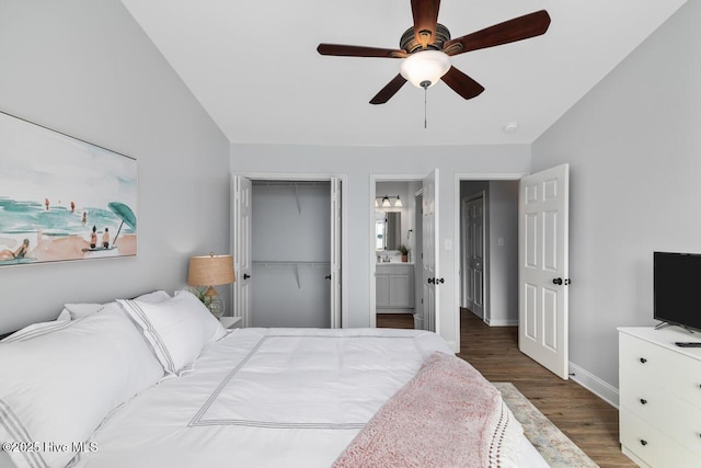 bedroom with dark wood-type flooring, ceiling fan, ensuite bathroom, and a closet