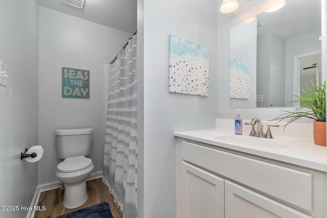 bathroom featuring hardwood / wood-style flooring, vanity, toilet, and a shower with shower curtain